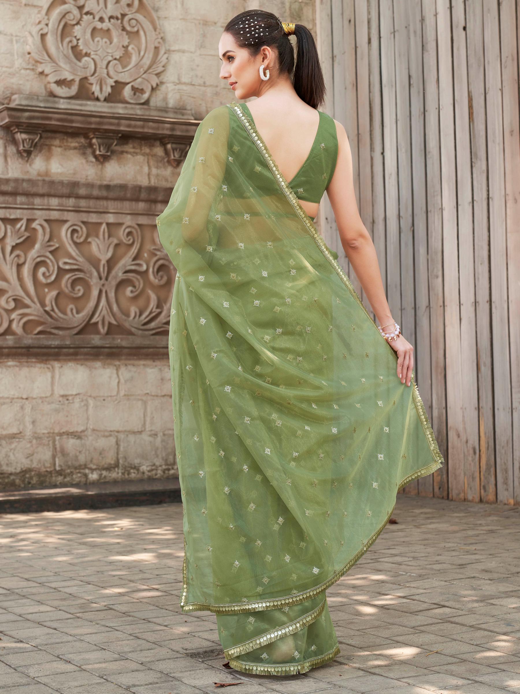 Green colored shimmer net saree with sequinned butti and embroidered border